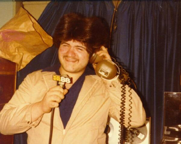 Photo of Johnny Calabro behind a microphone.